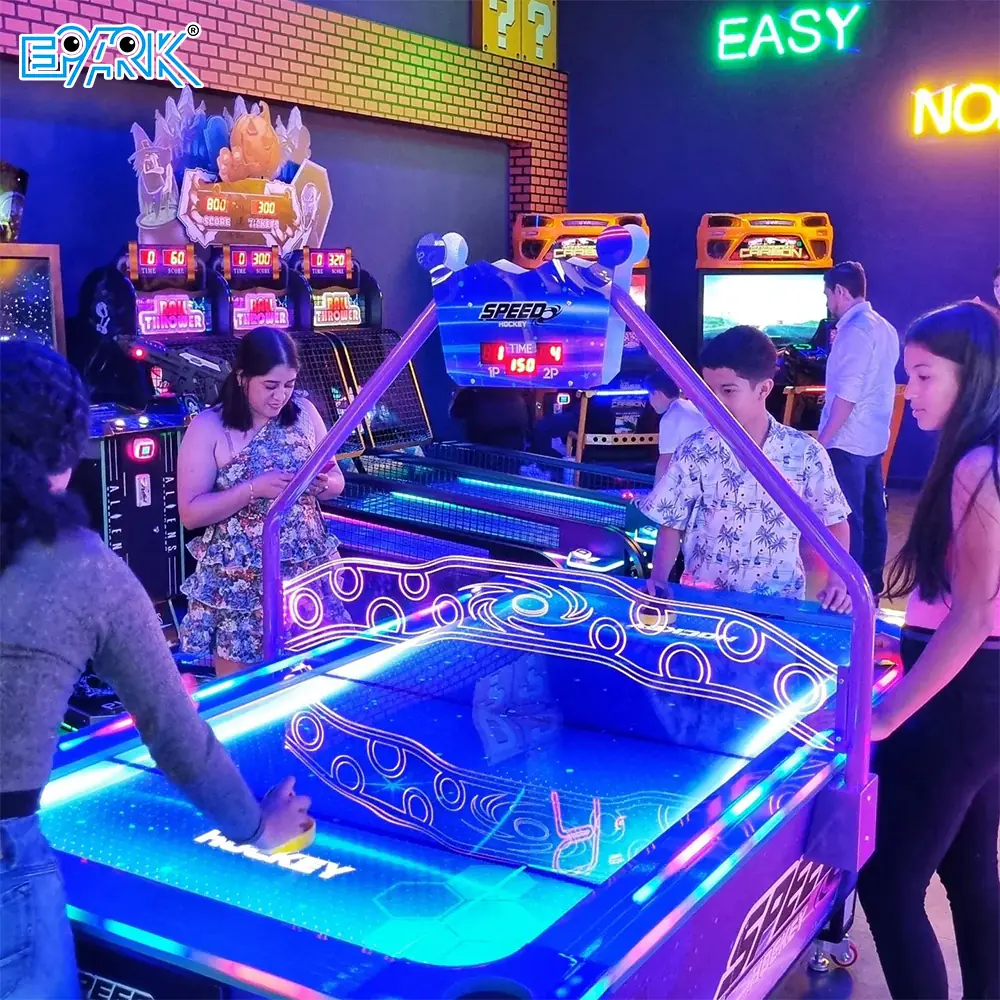 Visitors playing air hockey and arcade machines at an EPARK project in Ecuador