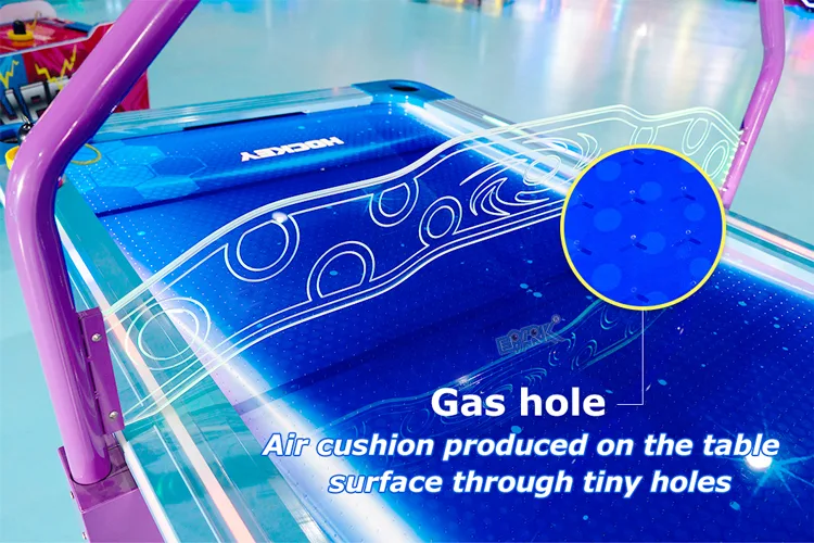 Airflow holes across the illuminated air hockey playfield