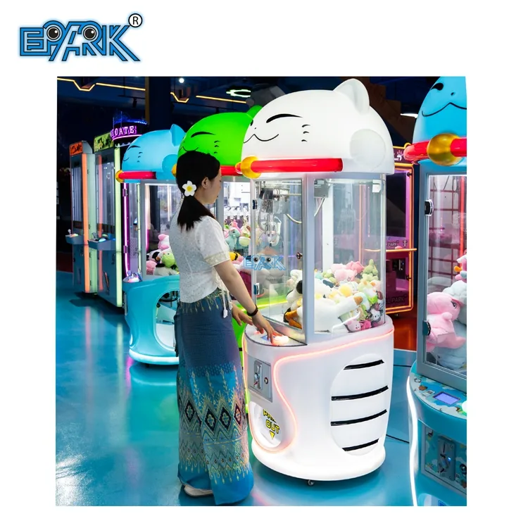 Player operating a cat-themed claw machine in an arcade