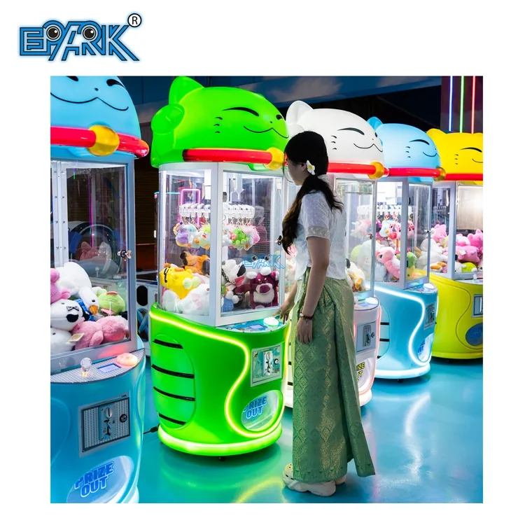 Player operating a green cat-themed prize clip machine
