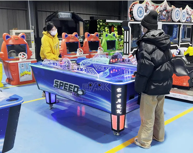 Two players using the coin-operated air hockey table in a showroom