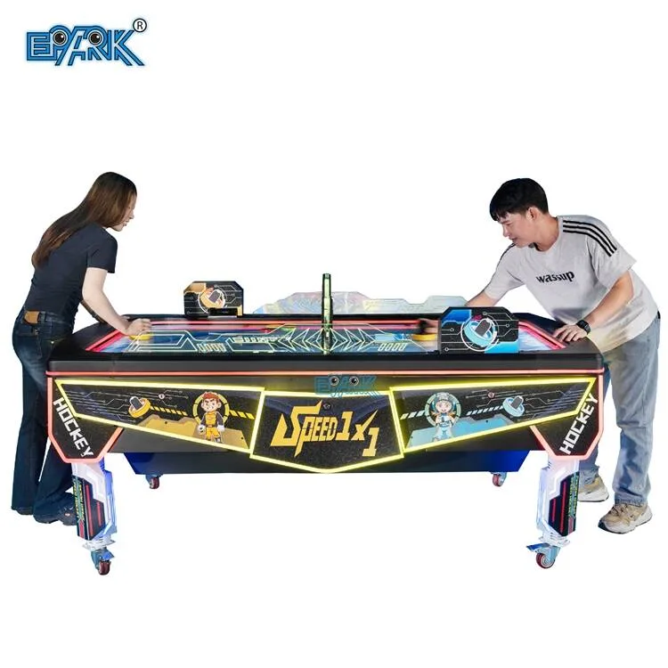 Two players using a commercial air hockey table with electronic scoring