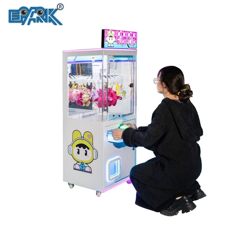 Player using a compact prize clip vending machine in an arcade