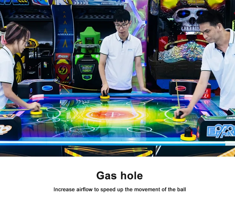 Players using the airflow playfield on the square air hockey table