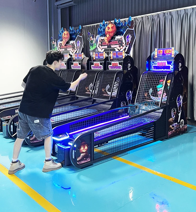 Player throwing a ball toward the target baskets on a single-lane arcade game