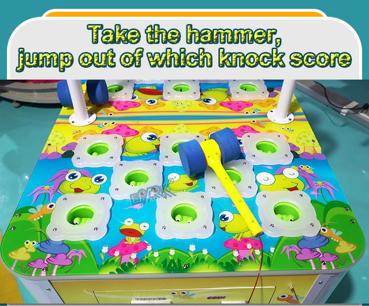 Close-up of pop-up frog targets and a blue and yellow hammer