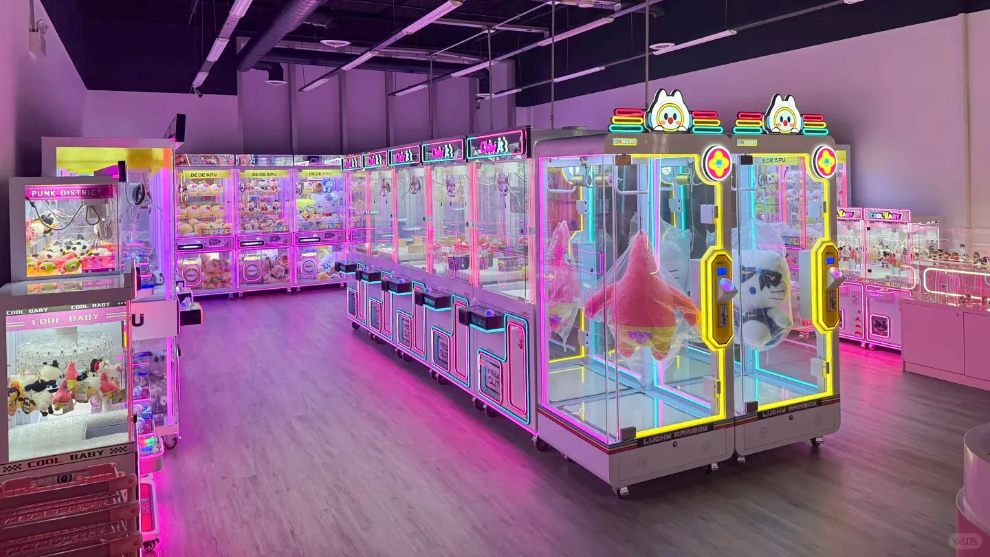 Commercial claw machine store with rows of illuminated prize machines