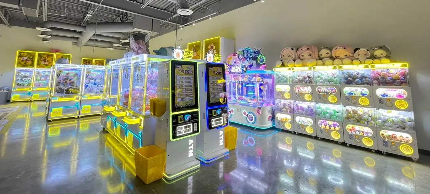 Real commercial claw machine store with illuminated machine rows