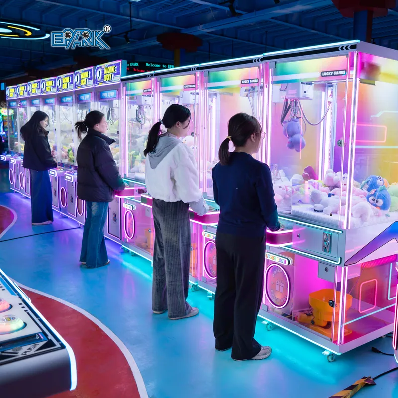 Row of colorful commercial claw machines with players