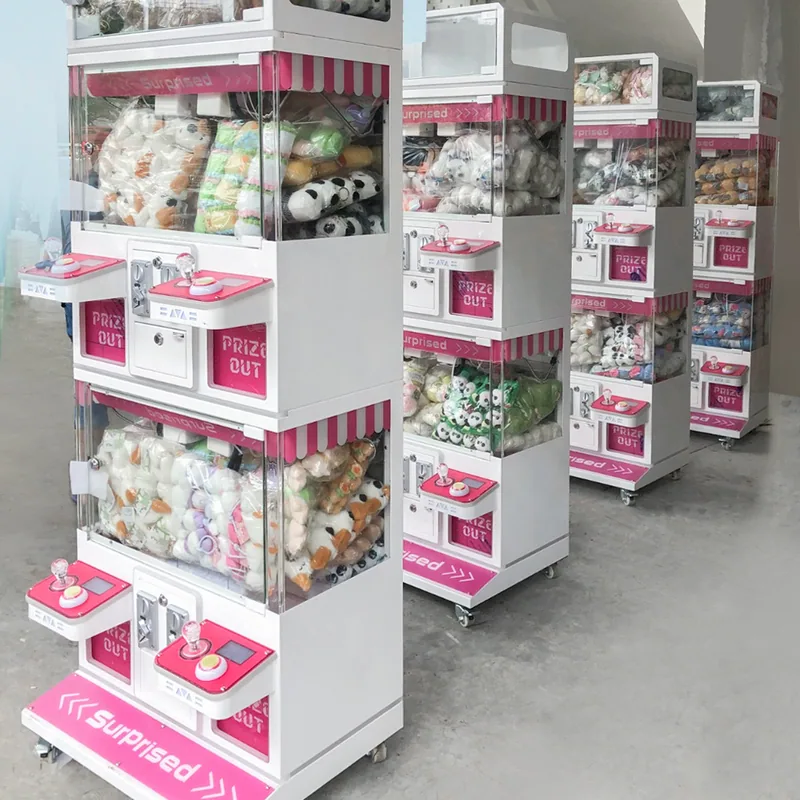 Four-player claw machines arranged for plush prizes